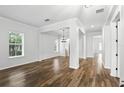 Bright living room featuring wood floors, neutral paint, large windows and an open concept design for entertaining at 4509 Belkin Ct, Orlando, FL 32814