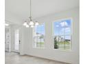 Bright dining room filled with natural light and elegant light fixture at 5204 Obsidian Gate Dr, Mount Dora, FL 32757