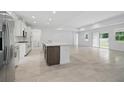 Open kitchen featuring a large island, and white cabinets at 5204 Obsidian Gate Dr, Mount Dora, FL 32757