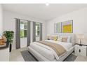 Modern bedroom with stylish window treatments, a cozy rug, and minimalist decor at 5226 Mahogany Dr, Mount Dora, FL 32757