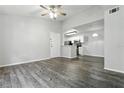 Inviting living room with wood floors, neutral paint, and a ceiling fan open to the kitchen at 5263 Images Cir # 306, Kissimmee, FL 34746