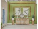 Grand foyer featuring a modern console table, decorative wall art, and a bright, inviting space at 5310 Teirgarten St, St Cloud, FL 34771