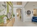 Elegant foyer with soaring ceilings, decorative wall art, and neutral flooring creating a welcoming ambiance at 5310 Teirgarten St, St Cloud, FL 34771
