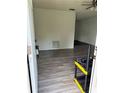 View through front door into a living room with wood-look floors and freshly painted white walls at 6308 Stanwin Dr, Apopka, FL 32712