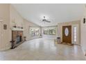 Bright living room featuring a fireplace, tile floors, and abundant natural light at 7263 Spring Villas Cir, Orlando, FL 32819