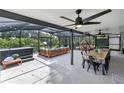 Spacious screened patio with ceiling fans, dining area, and lounge seating at 7809 Altavan Ave, Orlando, FL 32822