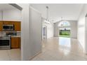 Bright, open-concept living room with tiled floors and large slider that provides outdoor view at 7952 Oakstone Ct, Orlando, FL 32822