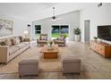 Bright living room with vaulted ceilings, neutral furniture, and tiled floors at 8994 Fort Jefferson Blvd, Orlando, FL 32822
