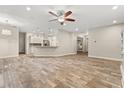 Spacious living room featuring wood-look tile flooring, neutral walls and an open floor plan at 917 Southern Oak Ln, Apopka, FL 32712