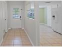 Bright entryway leading to an open kitchen with tile floors and access to the backyard at 1026 Mccully Ct, Oviedo, FL 32765