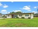 Well-kept home featuring a green lawn, complemented by a tidy landscape and neutral color palette at 110 N Sunland Dr, Sanford, FL 32773