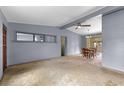 Spacious living room with a ceiling fan and an adjacent dining area with a wooden table set at 110 N Sunland Dr, Sanford, FL 32773