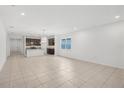Open floor plan with neutral tile flooring showcasing the kitchen and living area at 1323 Wood Line Dr, Deland, FL 32720