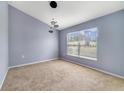Bright bedroom with a large window and modern lighting fixture at 1406 Kissimmee Ct, Kissimmee, FL 34759