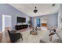 Cozy living area featuring comfortable seating, entertainment center, and access to the outdoor hot tub at 1406 Kissimmee Ct, Kissimmee, FL 34759