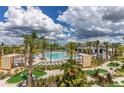 A community pool with lounge chairs and palm trees for a resort-like feel at 1452 Moon Valley Dr, Davenport, FL 33896