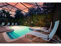 Enjoy this private screened-in pool with a hot tub and lounge chairs at 1452 Moon Valley Dr, Davenport, FL 33896