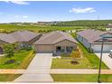 An aerial view of a single-story home in a Primary-planned community at 1797 Sundance Chase Rd, Minneola, FL 34715