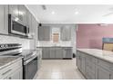 A modern kitchen with stainless steel appliances, granite countertops and island at 1797 Sundance Chase Rd, Minneola, FL 34715