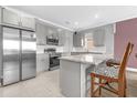 A well-equipped kitchen featuring stainless appliances, a granite island, and ample storage at 1797 Sundance Chase Rd, Minneola, FL 34715
