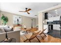 Bright living room with hardwood floors, stylish furniture, modern fan, and an open view of the kitchen at 1945 Bering Ave, Winter Park, FL 32789