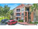 Condo exterior features balconies, parking, and mature landscaping at 1950 Summer Club Dr # 200, Oviedo, FL 32765