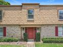 Charming townhome entrance featuring well-kept landscaping and a brick facade at 200 St Andrews Blvd # 911, Winter Park, FL 32792