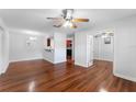Open-concept living space with hardwood floors, ceiling fan, and a view into the kitchen at 2041 Dixie Belle Dr # 2041C, Orlando, FL 32812