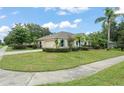 Charming exterior view showcasing lush landscaping and a well-maintained lawn on a sunny day at 2042 Hayfield Way, Apopka, FL 32712