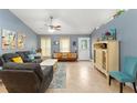 Bright living room with tile floors, a ceiling fan, light blue walls, and comfortable seating at 2042 Hayfield Way, Apopka, FL 32712