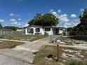 Modest single-story home with a chain-link fence and a covered carport at 2302 Greenwood St St, Deltona, FL 32738