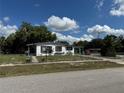 Quaint single-story house with a chain-link fence and a covered side patio at 2302 Greenwood St St, Deltona, FL 32738