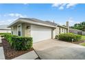 Attached two-car garage offers convenient parking and extra storage space, enhancing the home's functionality at 245 Meadow Bay Ct, Lake Mary, FL 32746