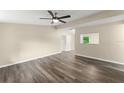 Spacious living area with modern flooring, natural light, and a ceiling fan, perfect for relaxing and entertaining guests at 247 Toms Rd, Debary, FL 32713