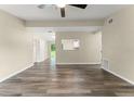 Bright living room featuring stylish wood flooring, neutral paint, and a ceiling fan, creating a warm and inviting space at 247 Toms Rd, Debary, FL 32713