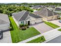 Beautiful single Gathering home featuring a lush lawn, well-manicured landscaping, and a brick paver driveway at 3504 Cayugas Loop, St Cloud, FL 34772