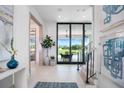 Inviting foyer with modern finishes, a view of the pool and golf course, and elegant decor at 4007 Grande Brick Loop # 13, Orlando, FL 32837