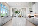 Open-concept kitchen featuring an expansive marble island, modern appliances, and views of the manicured golf course at 4007 Grande Brick Loop # 13, Orlando, FL 32837