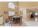 Bright dining area boasts abundant natural light, a modern chandelier, and views of the backyard at 425 Sterling Lake Dr, Ocoee, FL 34761
