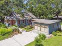 Blue home with a red door, detached garage, and landscaping at 524 S Lakeview Ave, Winter Garden, FL 34787