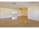 Expansive living space featuring tiled flooring and a seamless flow into the adjacent dining area at 5654 Minute Man Ct, Orlando, FL 32821