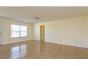 Bright, open living room with neutral walls, tile floors, and a large window filling the space with natural light at 5654 Minute Man Ct, Orlando, FL 32821