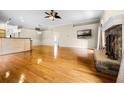 Open-concept living area with hardwood floors, stone fireplace, and bar counter at 707 Heritage Ne Dr, Winter Haven, FL 33881