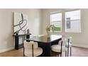 Elegant dining room with modern decor and an abundance of natural light, showcasing a sleek table and stylish chairs at 7409 Fairgrove Ave, Windermere, FL 34786