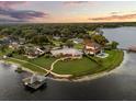 Expansive waterfront estate featuring manicured lawns, mature trees, a private dock, and peaceful lake views at 4318 Waterfront Pkwy, Orlando, FL 32806