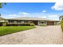 Charming single-story home with a brick driveway, well-manicured lawn, and attractive curb appeal at 4318 Waterfront Pkwy, Orlando, FL 32806
