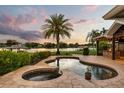 Gorgeous outdoor living space with a custom pool, spa, and lush tropical landscaping overlooking the lake at 4318 Waterfront Pkwy, Orlando, FL 32806