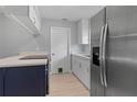 Modern kitchen features stainless steel refrigerator and white cabinets at 1066 Swanson Dr, Deltona, FL 32738