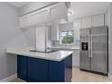 Bright kitchen with stainless steel appliances, white cabinetry, and an island with cooktop at 1066 Swanson Dr, Deltona, FL 32738