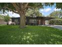 Beautifully landscaped home with mature tree in front yard and covered parking at 116 E Lauren Ct, Fern Park, FL 32730